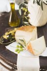 Cheese with olives and olive oil — Stock Photo