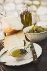 Cheese with olives and olive oil — Stock Photo