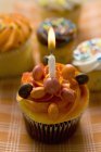 Pasteles pequeños con una vela de cumpleaños - foto de stock
