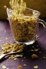 Crunchy muesli in measuring jug — Stock Photo