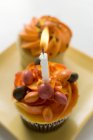 Assorted muffins, one with birthday candle — Stock Photo
