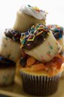 Colorful decorated muffins in pile — Stock Photo