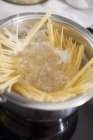 Bundle of spaghetti pasta in pot — Stock Photo
