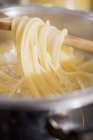 Cooked ribbon pasta on spoon — Stock Photo