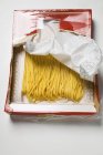 Dried Spaghetti pasta in packaging — Stock Photo