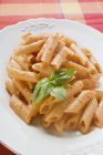 Penne pasta with tomato cream sauce — Stock Photo
