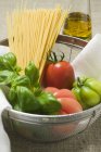 Tomatoe and spaghetti in sieve — Stock Photo