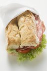 Бутерброд з ковбасою, помідорами та листям салату — стокове фото