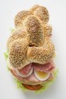 Sesame plait filled with salami — Stock Photo