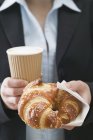 Pretzel-style croissant and coffee — Stock Photo