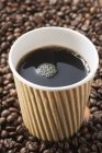 Black coffee in paper cup — Stock Photo