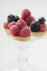 Berry tarts on cake stand — Stock Photo
