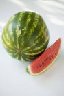 Watermelon with fresh ripe slice — Stock Photo