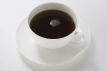 Black coffee in white cup — Stock Photo