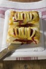 Closeup view of two raspberry turnovers with server on paper plate — Stock Photo