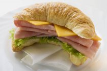 Croissant with ham and cheese — Stock Photo