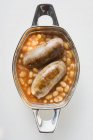 Baked beans with sausages — Stock Photo