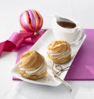 Cream puffs with chocolate cream — Stock Photo