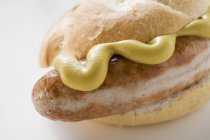 Bratwurst Sausage with mustard in bread roll — Stock Photo