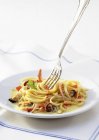 Bavette pasta with seafood and coconut — Stock Photo