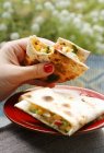 Closeup view of female hand holding Quesadilla with sweetcorn filling — Stock Photo