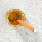 Apricot jam with spoon — Stock Photo