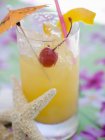 Fruit cocktail with cherry and lemon peel — Stock Photo
