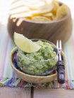 Guacamole with nachos in bowls — Stock Photo