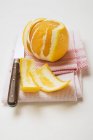 Peeled orange on napkin — Stock Photo