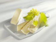 Sliced Brie with grapes — Stock Photo