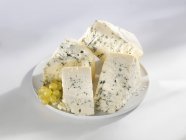 Four wedges of blue cheese — Stock Photo