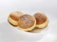 Three doughnuts on plate — Stock Photo
