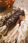 Cobs of corn as decoration on plate — Stock Photo