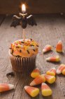 Cupcake with bat candle — Stock Photo