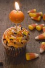 Cupcake with pumpkin candle — Stock Photo