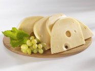 Swiss cheese with grapes — Stock Photo