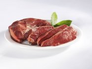 Sliced beef heart with bay leaves — Stock Photo