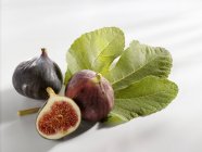 Fresh figs with half and leaf — Stock Photo