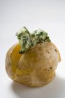 Baked potato with herb butter — Stock Photo