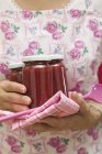 Woman holding jars of jam — Stock Photo