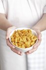 Closeup view of person holding a bowl of cereal pillows — Stock Photo