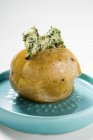 Baked potato with herb butter — Stock Photo