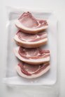 Raw pork chops on paper — Stock Photo