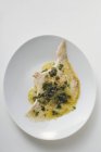 Top view of skate in caper sauce on white plate — Stock Photo