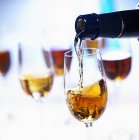 Closeup view of pouring Sherry to a glass — Stock Photo