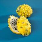 Fresh yellow pitahaya with halves — Stock Photo