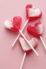 Four heart-shaped lollipops — Stock Photo
