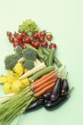 Assorted baby vegetables on light green surface — Stock Photo