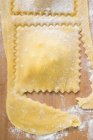 Cutting out homemade ravioli pasta — Stock Photo