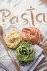 Colorful ribbon pasta and spoon — Stock Photo